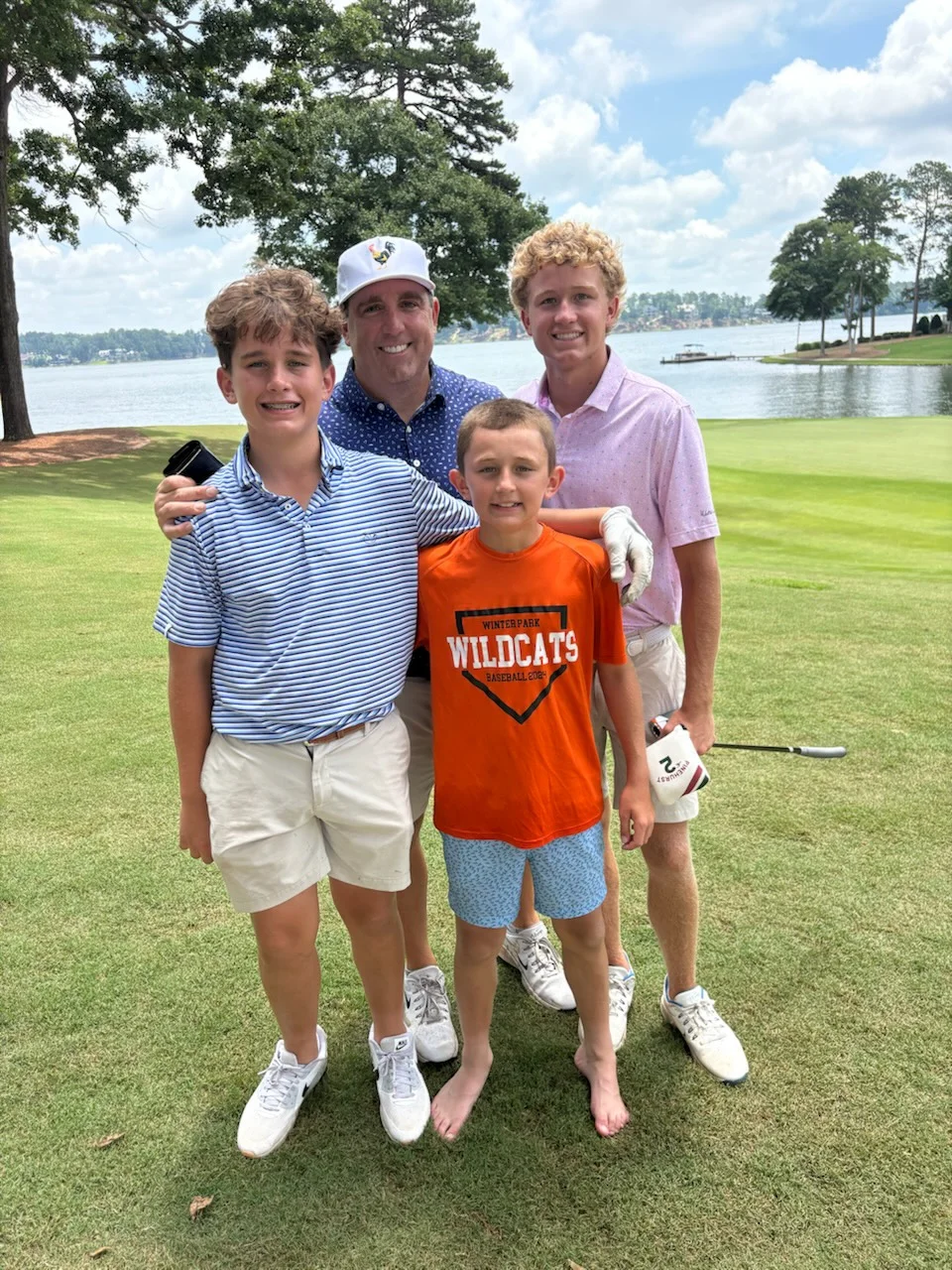 Peter Sirianni with his family on a lakeside golf course
