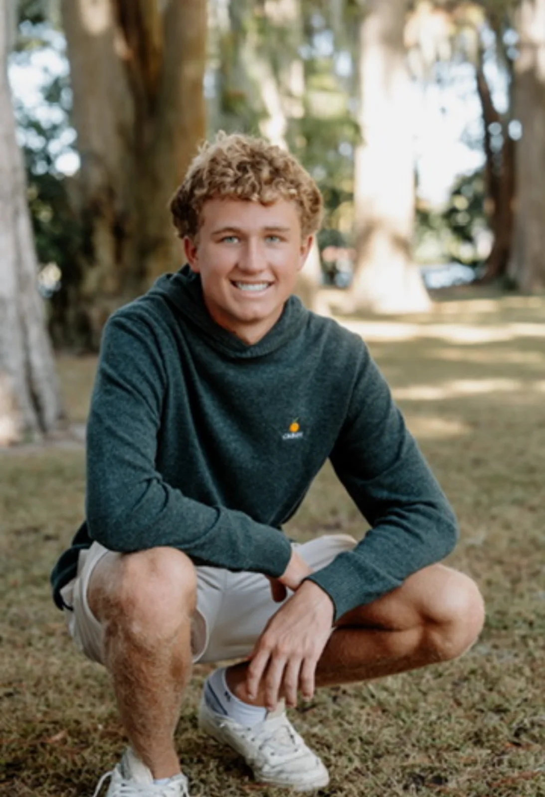 Peter Sirianni smiling outdoors in a dark hoodie