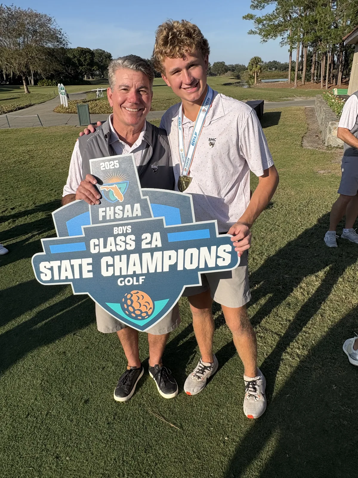 Peter Sirianni holding the 2025 FHSAA Class 2A boys golf state champions sign